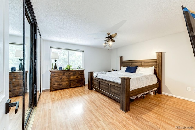 7840 W Portland Ave, Littleton, CO 80128 - bedroom with light wood-type flooring, a textured ceiling, and ceiling fan