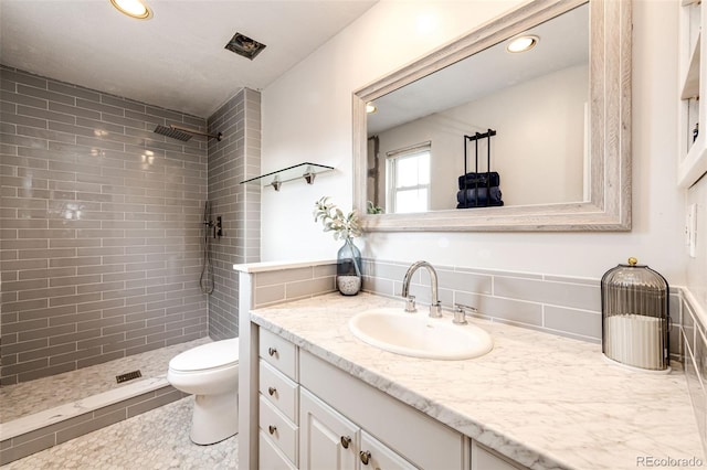 7840 W Portland Ave, Littleton, CO 80128 - full bathroom featuring tiled shower, vanity, and recessed lighting