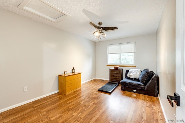 7840 W Portland Ave, Littleton, CO 80128 - sitting room featuring attic access, light wood finished floors, and ceiling fan