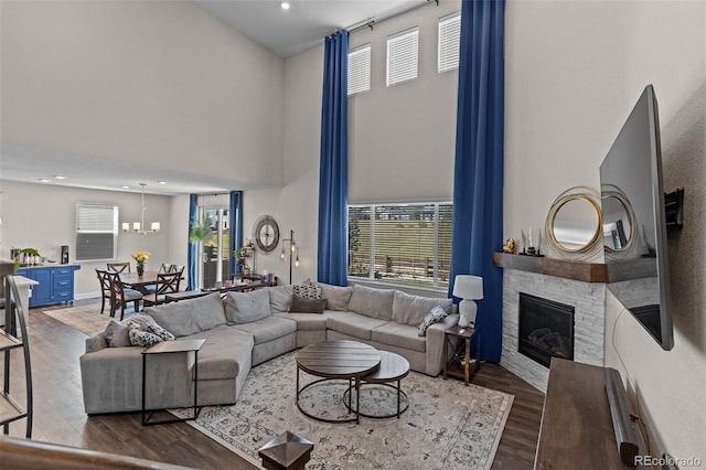 379 Silver Rock Trl, Castle Rock, CO 80104 - living room with a high ceiling, dark wood-type flooring, healthy amount of natural light, a fireplace, and recessed lighting