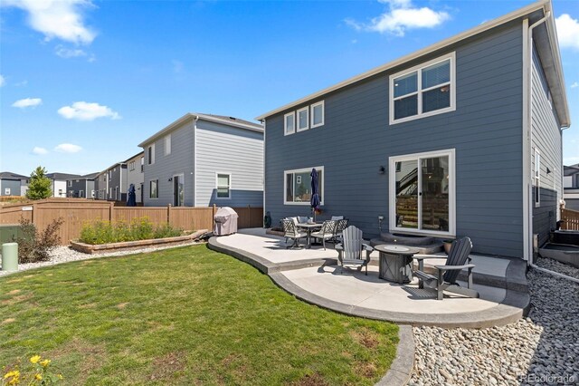379 Silver Rock Trl, Castle Rock, CO 80104 - back of property with a patio area, an outdoor fire pit, and a residential view