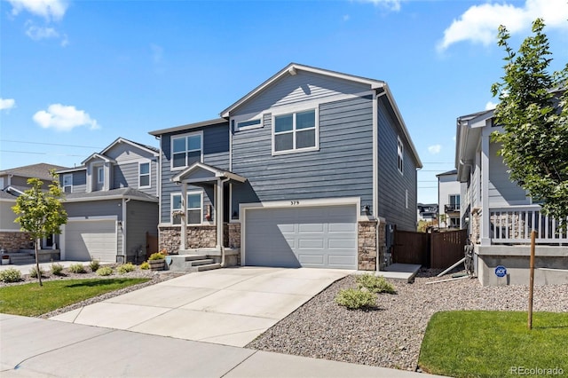 379 Silver Rock Trl, Castle Rock, CO 80104 - view of front of home featuring a garage, concrete driveway, and stone siding