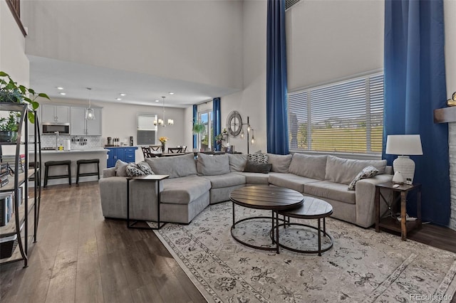 379 Silver Rock Trl, Castle Rock, CO 80104 - living room with a high ceiling, a chandelier, dark wood finished floors, and recessed lighting