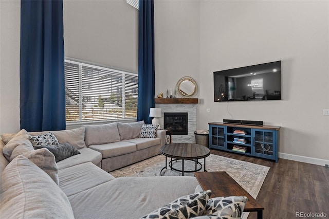 379 Silver Rock Trl, Castle Rock, CO 80104 - living room with a towering ceiling, wood finished floors, and a stone fireplace