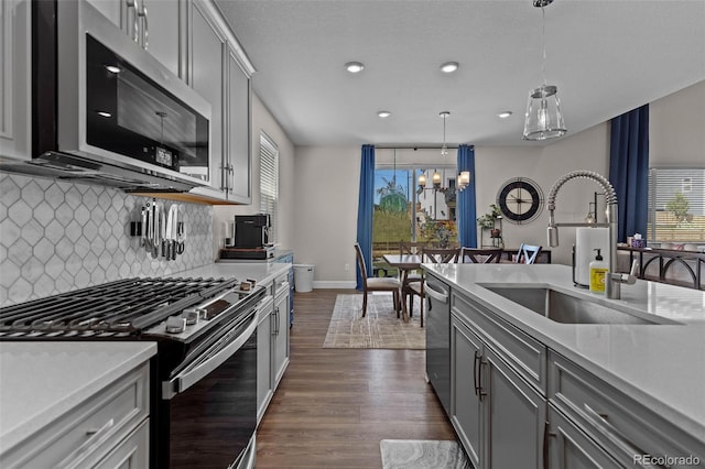 379 Silver Rock Trl, Castle Rock, CO 80104 - kitchen with appliances with stainless steel finishes, gray cabinetry, tasteful backsplash, light countertops, and recessed lighting