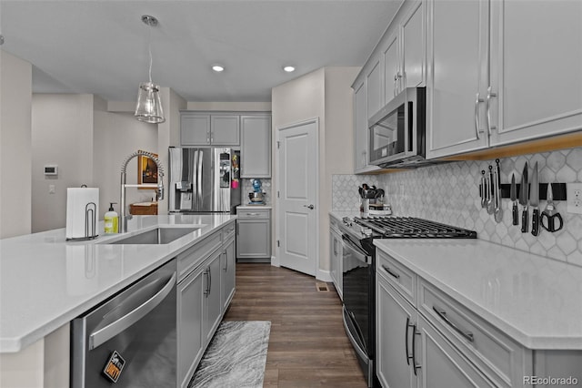 379 Silver Rock Trl, Castle Rock, CO 80104 - kitchen featuring stainless steel appliances, gray cabinetry, dark wood-style floors, light countertops, and recessed lighting
