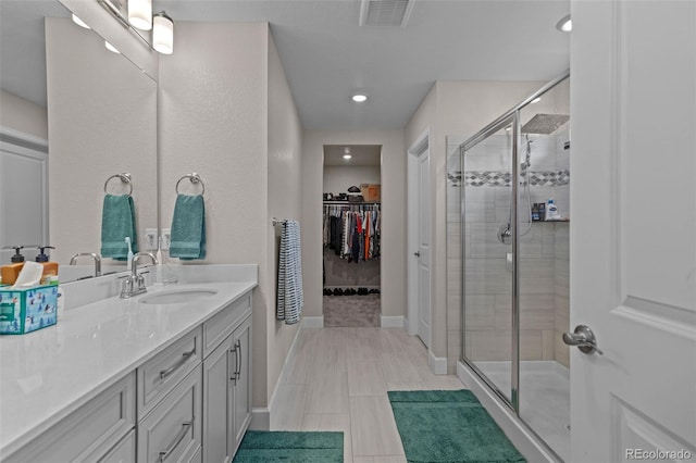 379 Silver Rock Trl, Castle Rock, CO 80104 - bathroom with vanity, a shower stall, a walk in closet, and recessed lighting