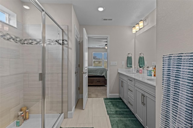379 Silver Rock Trl, Castle Rock, CO 80104 - full bathroom with double vanity, ensuite bathroom, a stall shower, ceiling fan, and recessed lighting