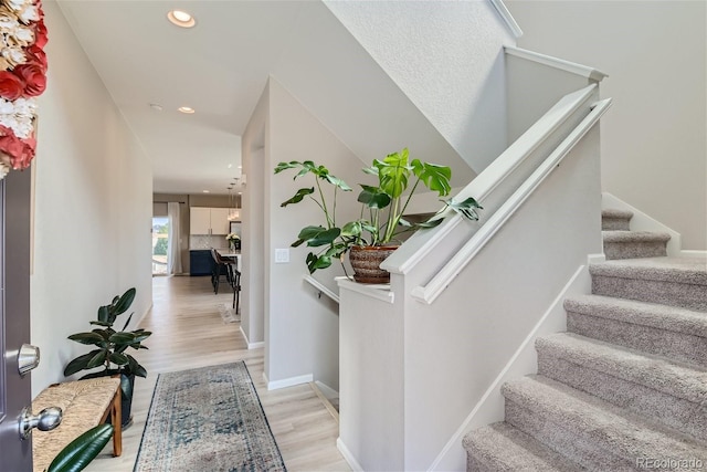 foyer entrance with light hardwood / wood-style floors