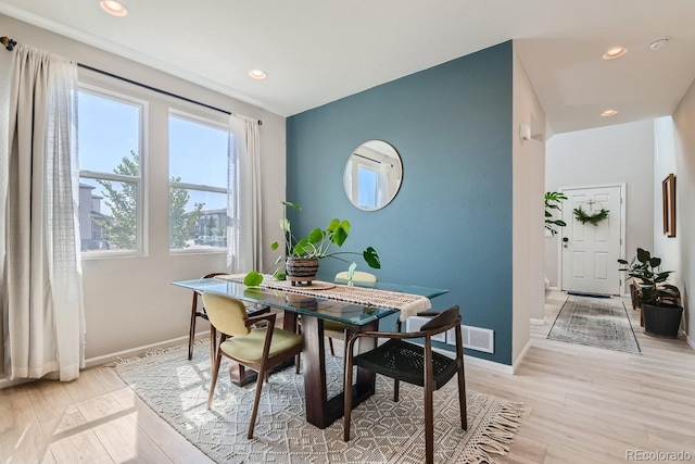 dining room featuring light hardwood / wood-style floors and a healthy amount of sunlight