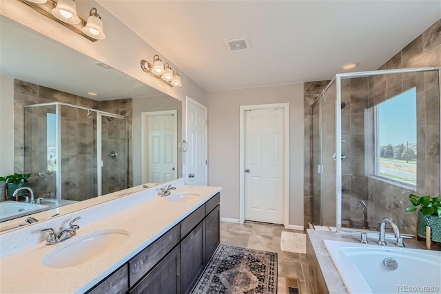 bathroom with shower with separate bathtub and vanity