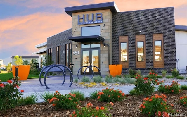 view of outdoor building at dusk