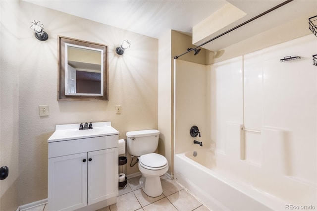 bathroom featuring toilet, tub / shower combination, vanity, tile patterned flooring, and baseboards