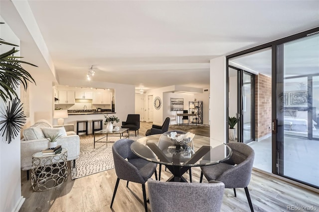 1551 Larimer St Unit 703, Denver, CO 80202 - dining area with light wood finished floors and expansive windows