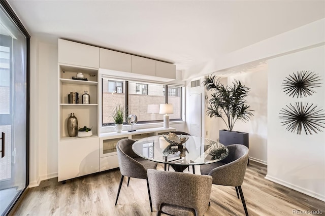 1551 Larimer St Unit 703, Denver, CO 80202 - dining room with light wood-style floors and baseboards