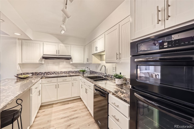 1551 Larimer St Unit 703, Denver, CO 80202 - kitchen with dishwashing machine, a sink, white cabinetry, and light wood-style flooring