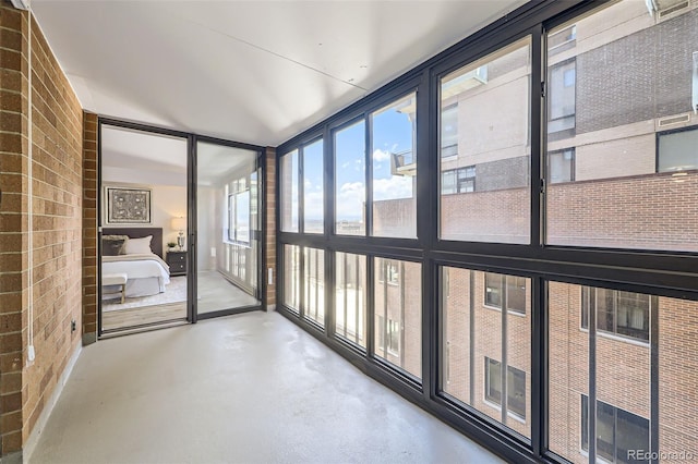 1551 Larimer St Unit 703, Denver, CO 80202 - unfurnished sunroom with finished concrete floors and brick wall
