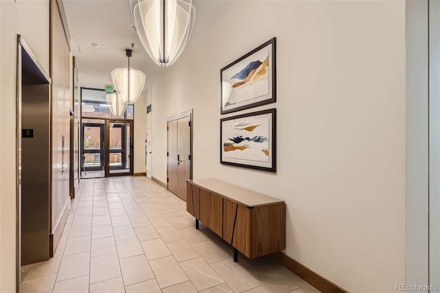 1551 Larimer St Unit 703, Denver, CO 80202 - hall featuring elevator, baseboards, and light tile patterned floors