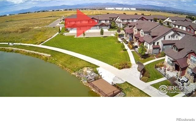 bird's eye view featuring a residential view and a water view