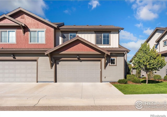 view of front of home featuring driveway, board and batten siding, and an attached garage