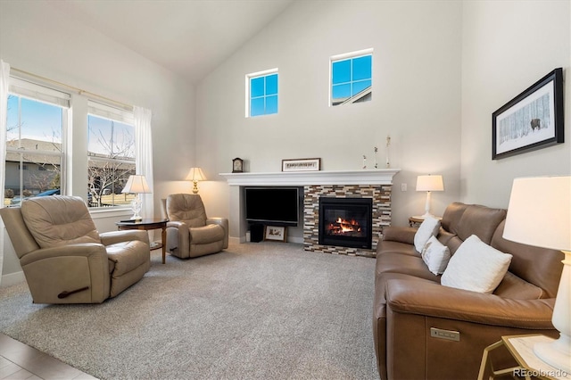 living area featuring carpet flooring, a fireplace, and high vaulted ceiling