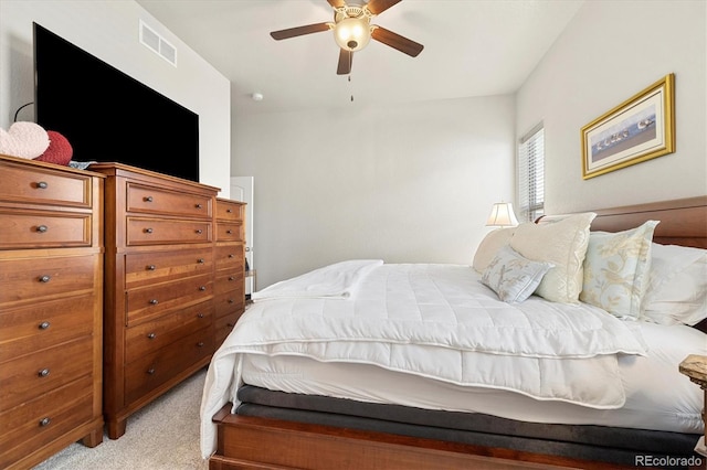 bedroom featuring visible vents, light colored carpet, and a ceiling fan