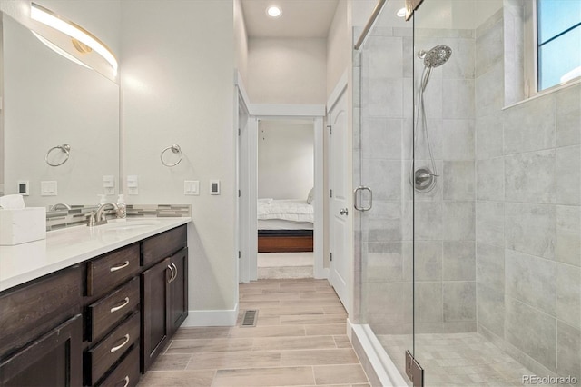 ensuite bathroom featuring visible vents, ensuite bathroom, vanity, and a shower stall