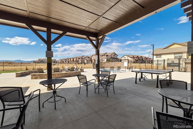 view of patio with a residential view and fence