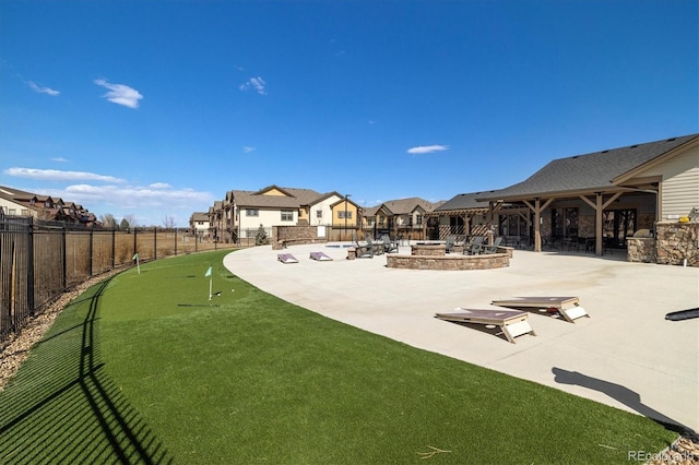 exterior space featuring a residential view, a patio, fence private yard, and an outdoor fire pit