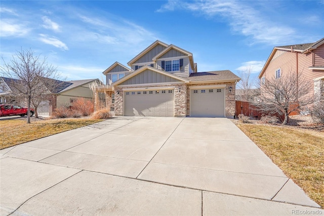 craftsman-style house featuring an attached garage, board and batten siding, stone siding, driveway, and a front lawn