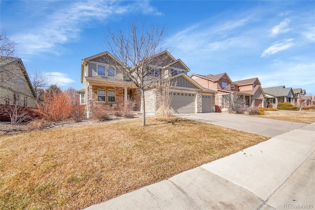 view of front of property featuring concrete driveway, board and batten siding, a front yard, a residential view, and stone siding