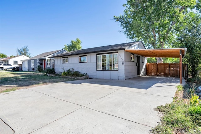 ranch-style house featuring a carport and a front yard