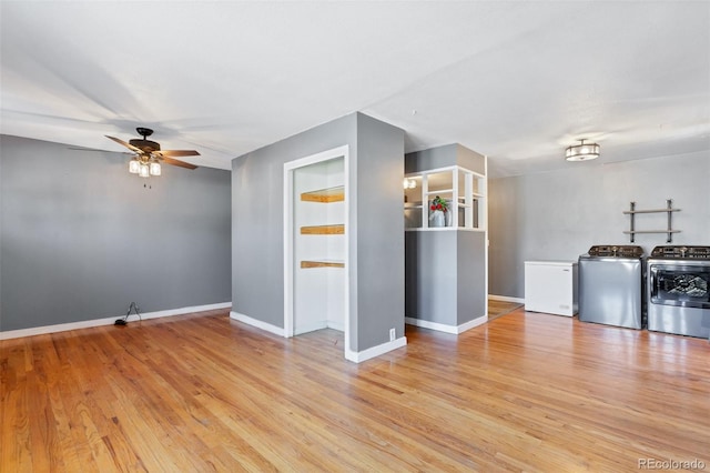 unfurnished living room with washing machine and clothes dryer, light hardwood / wood-style floors, and ceiling fan