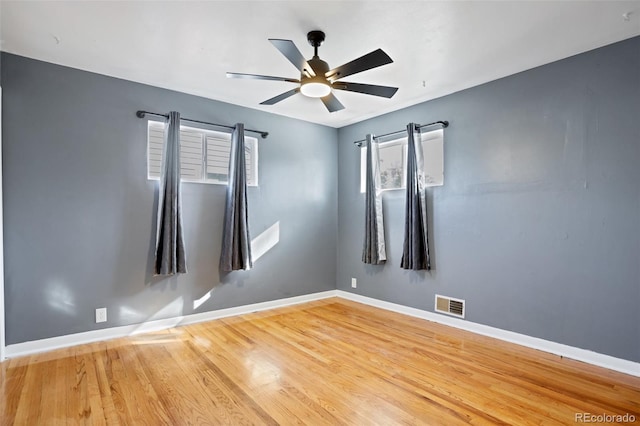 spare room featuring ceiling fan and hardwood / wood-style floors