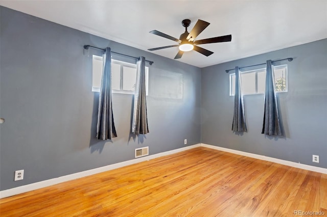 empty room with light wood-type flooring and ceiling fan