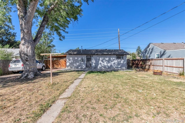 back of house with a lawn