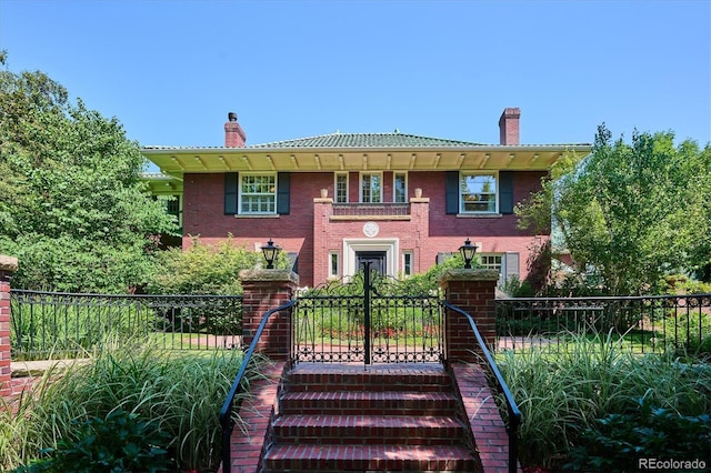 colonial home featuring brick siding, fence, and a chimney