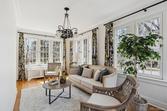 sunroom / solarium featuring radiator and a notable chandelier