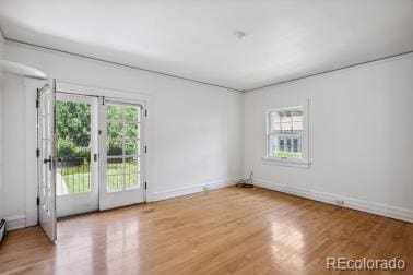 spare room with light wood-style flooring and baseboards