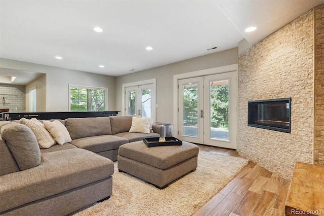 9880 E Progress Cir, Greenwood Village, CO 80111 - living room with wood finished floors, recessed lighting, french doors, and a fireplace