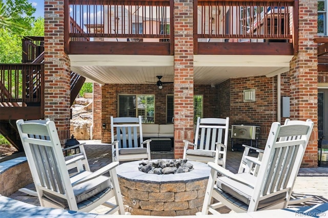 9880 E Progress Cir, Greenwood Village, CO 80111 - view of patio featuring ceiling fan, a balcony, and an outdoor living space with a fire pit