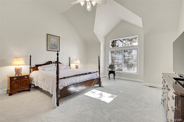 bedroom featuring a ceiling fan, light carpet, high vaulted ceiling, and baseboards