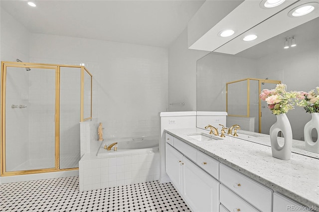 bathroom with recessed lighting, a garden tub, a shower stall, and vanity