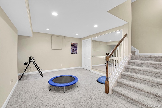 exercise room featuring carpet floors, recessed lighting, and baseboards