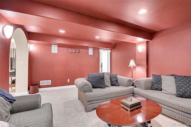 carpeted living room with recessed lighting, visible vents, a textured ceiling, beamed ceiling, and baseboards