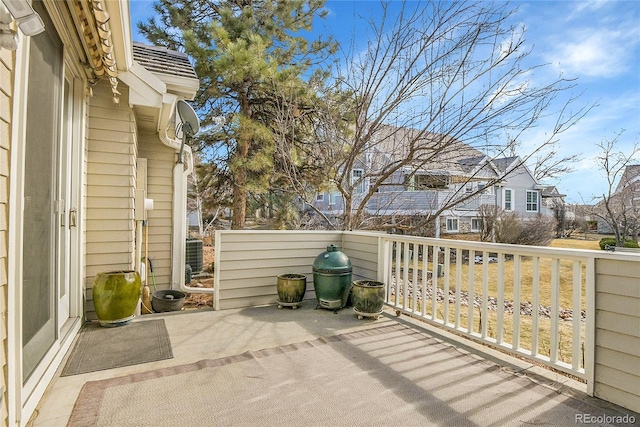 view of patio / terrace featuring a residential view and central AC unit