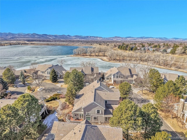 drone / aerial view with a residential view and a water and mountain view