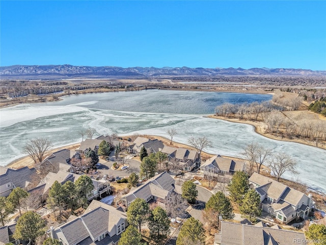 drone / aerial view featuring a residential view and a water and mountain view