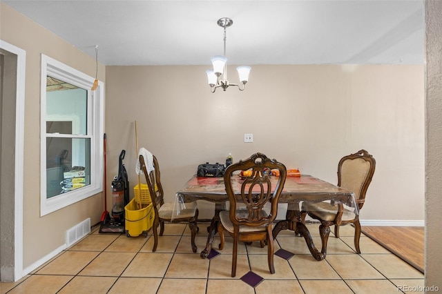 11192 E 7th Ave, Aurora, CO 80010 - dining area with light tile patterned floors and a chandelier