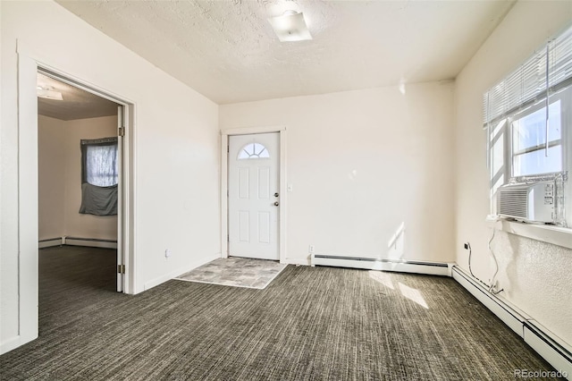 carpeted entrance foyer with cooling unit, a textured ceiling, and baseboard heating